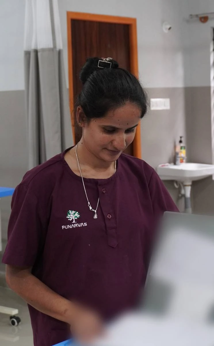 A Punarvas nurse reviewing a patient’s care file